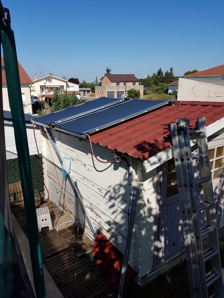 Les panneaux chauffe piscine Sunberry posés sur le toit de l'abris de jardin